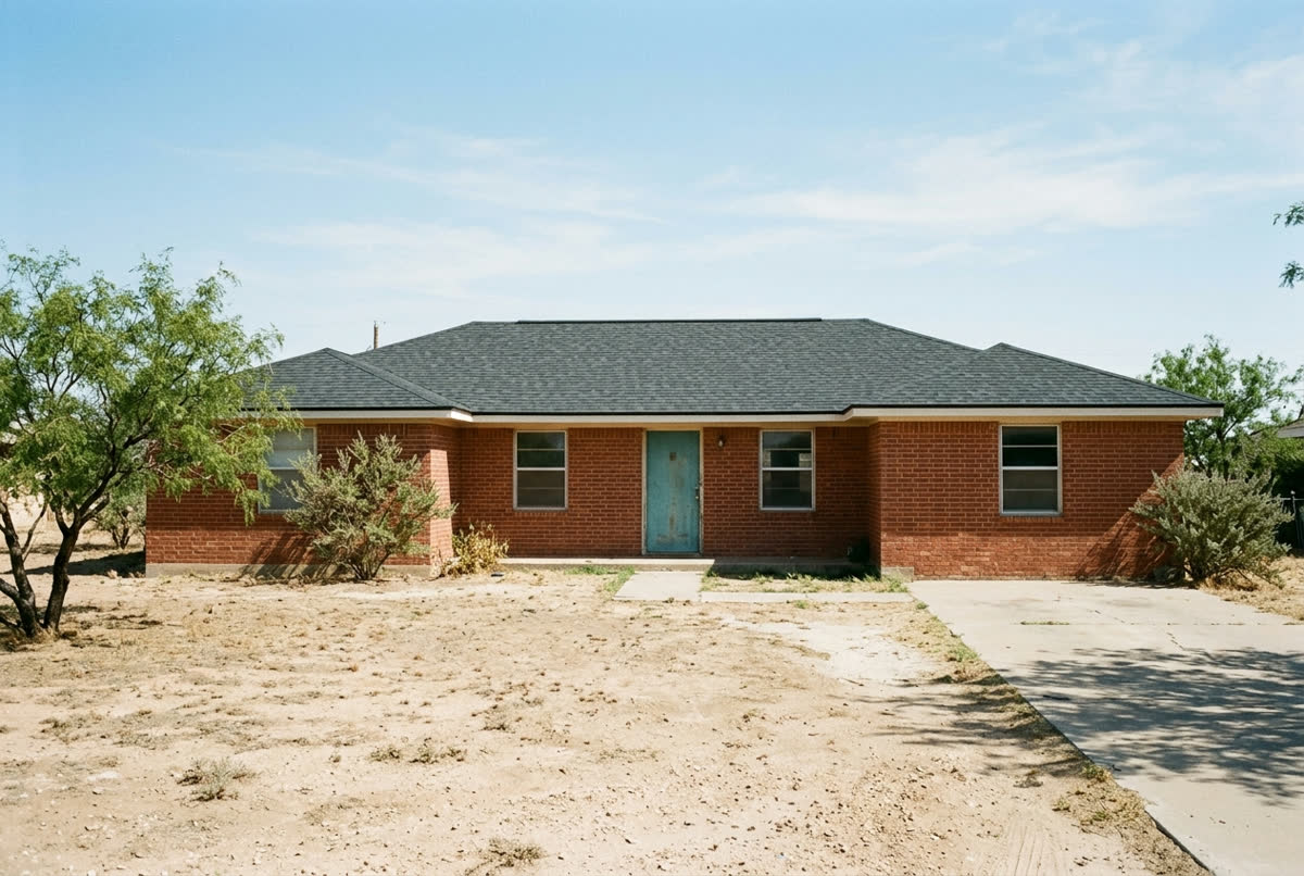 Sample photo: the same brick ranch house with a new charcoal shingle roof.