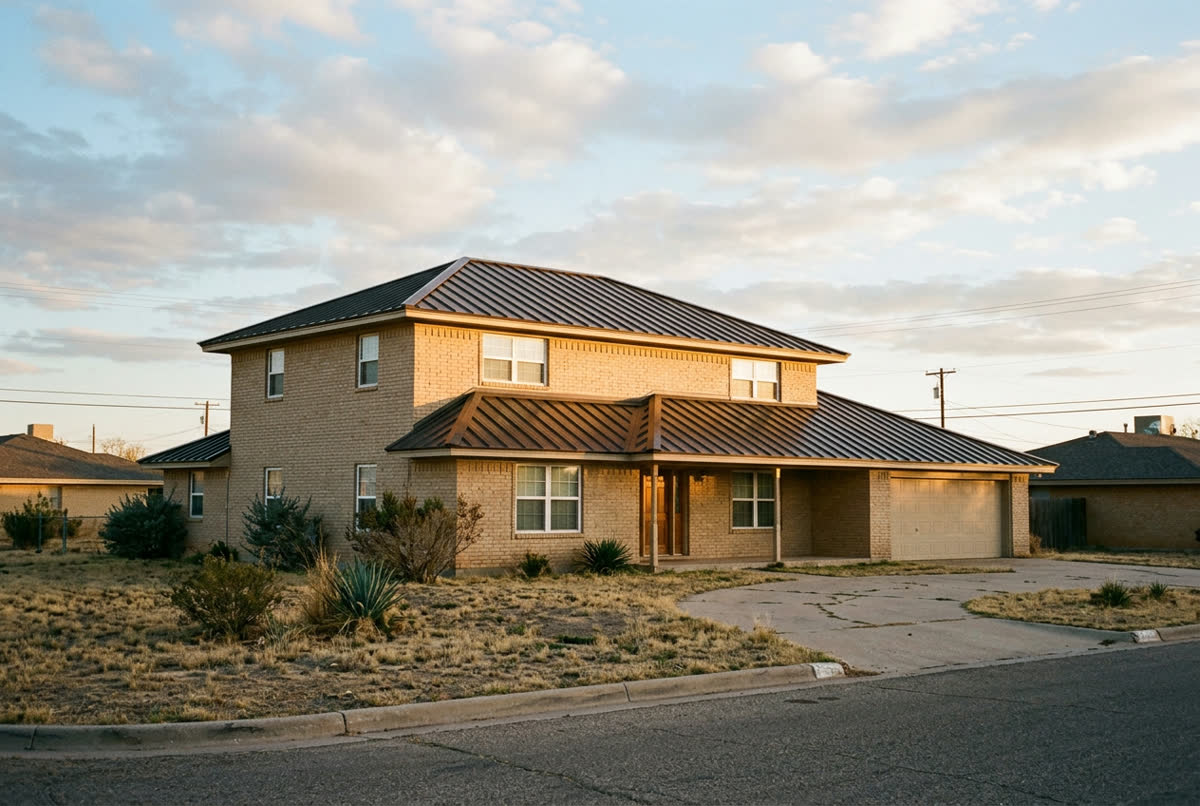 Sample photo: the same two-story house with a new bronze standing-seam metal roof.